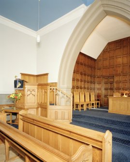 Interior.
View of Chancel from W showing the pulpit and reused panelling.