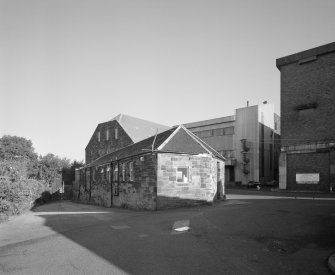 View from SW of gatehouse and offices (foreground), former maltings block (background centre) with new steel-clad block for Saladin boxes, and new whisky bond (right)