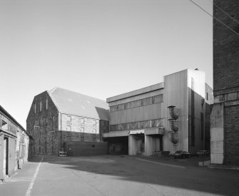 View from S of SW end of maltings blocks, showing steel-framed extension associated with the conversion to Saladin-Box maltings