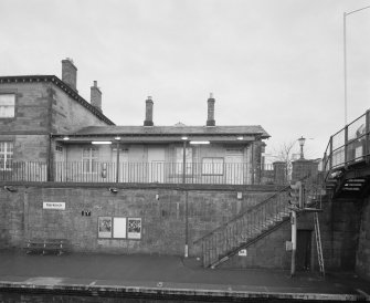 View across down platform to station buildings from E.