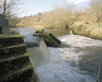 View of river embankment on Black Cart River at entrance to lade.