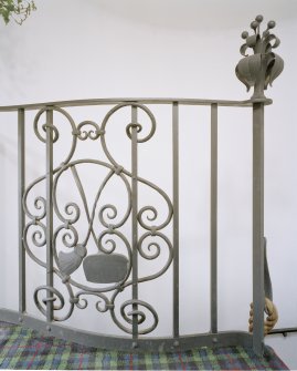 Interior. Spiral stair detail of Thomas Hadden wrought iron balustrade with curling equpment