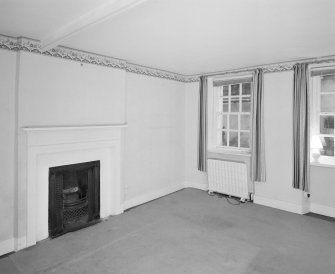 Interior. Ground floor View of bedroom 2 in E wing from NW showing 18th century fireplace