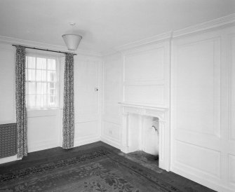 Interior. Ground floor View of study from SW in SE wing showing 18th century fireplace and panelling