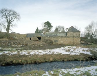 General view of the mill from SSW, with kiln at S end of the range (right), and water wheel to left