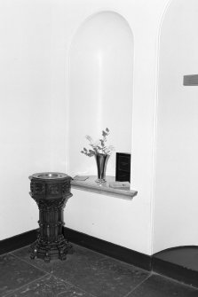 Interior, detail of arched niche and collection stand