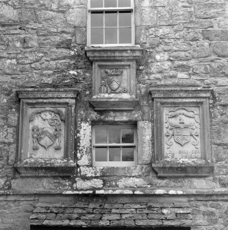 Detail of armourial panels above door to NW (principal) elevation