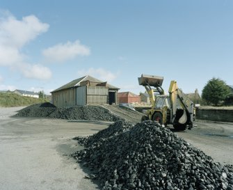 View from SW of former goods station building, being used by a coal merchant