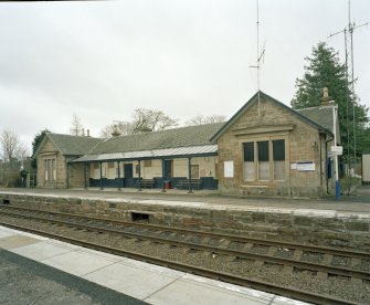 View from N of NE side of station building, facing the N-bound platform