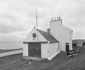 Detailed view from E of coastguard station, with houses behind