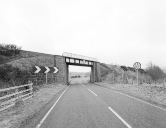 General view of railway bridge from E, showing granite abutments and single steel truss