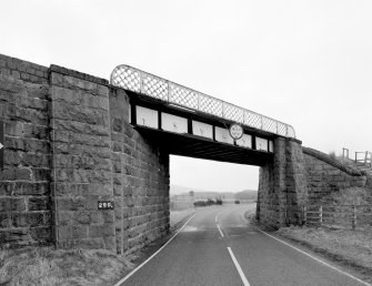 View of railway bridge from NW, showing granite abutments and single steel truss