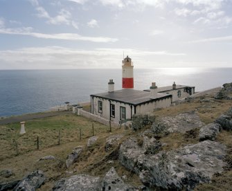 View from N looking down onto lighthouse compound, with keepers' house in foreground