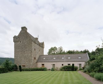 General view of tower house and extension from E