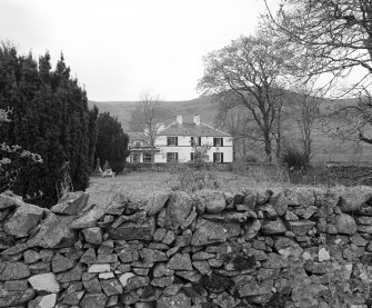General view from E across garden showing setting.