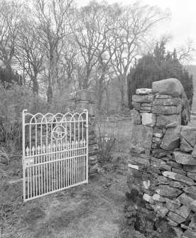 Detail of wrought iron garden gate to E with ' C H' monogram.