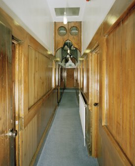 Interior. first floor View of corridor from N showing panelling and cusped screen arches