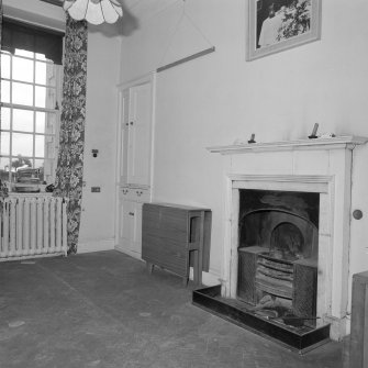 Interior. View of housekeepers room from NE showing fireplace with register grate