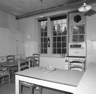 Interior. View of kitchen from SSE showing original tiling and window