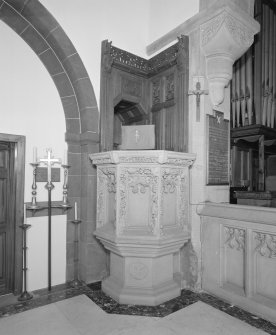 Interior.
Detail of gothic tracery pulpit and panelling of 1903 by H O Tarbolton.