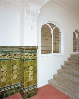 Interior, first floor landing detail of tiled dado and internal window into church