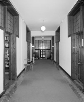 Interior, view of basement corridor from North showing glazed screens