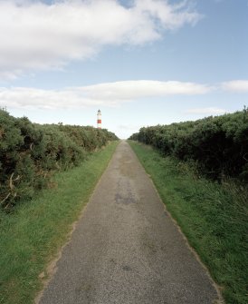 Distant view up access road from SW