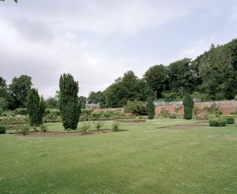 View of garden from SE showing gardeners house and glasshouses beyond