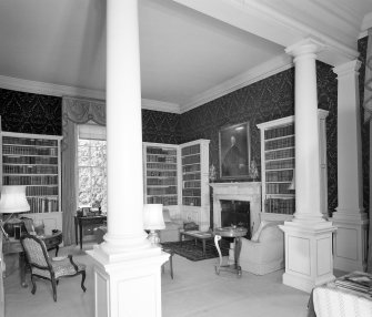 Interior. View of ground floor library from SE through columned screen