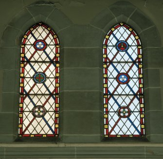 Interior. 
Detail of stained glass in the aisle at ground level.