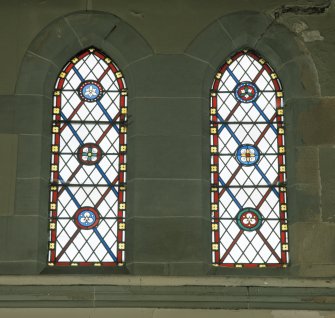 Interior. 
Detail of stained glass in the aisle at ground level.