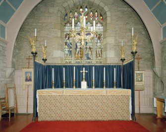 Interior. Altar from W  showing angel topped riddel posts by J Ninian Comper of 1903 and 15th century chandelier