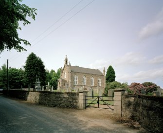 View from SE showing church, churchyard and walls.