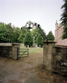 View of main gate from S with wrought iron archway and lantern.