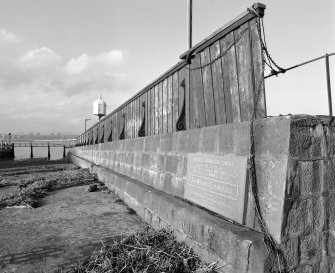 View of central wall (including commemorative plaque) from S, looking down the ramp towards the Tay