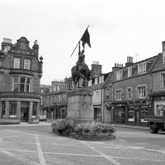 View of statue commemorating the return of Hawick callants from Holnshole in 1514 by W F Beattie (1914) from WSW
