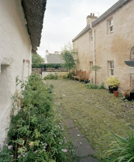 View of cobbled yard from S