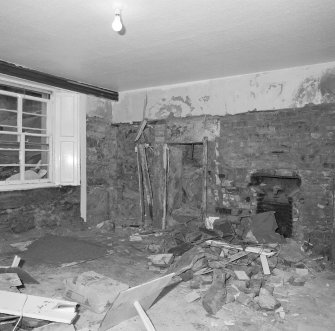 Interior. Basement. View of North corner room from South showing remains of kitchen fireplace