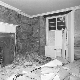 Interior. Basement. View of West corner room from East showing window and fireplace