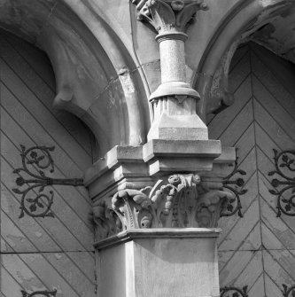 Detail of carved foliate capital between principal doorways