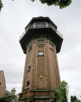 View looking up to tower from West, showing 1879 date plaque