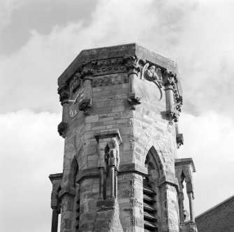 Detail of tower showing clock, elaborate carving and bell chamber louvres.