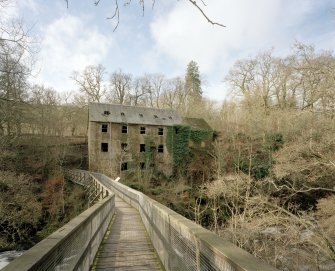 General view from E of NE side of mill, overlooking the River Ericht, with footbridge in foreground