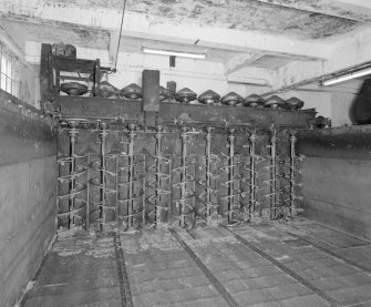 Saladin Maltings. Interior detail inside an empty Saladin box, showing gantry carrying ten helixes, the rotation of each of which turns the steeped barley, ensuring even germination.  The gantry moves up and down the box, is driven by electric motors, and also continuously moistens the barley with fine sprays of water.