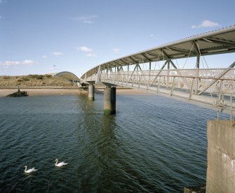 Oblique view from S along SW side of the bridge, with 'The Bid Idea' visible in the background