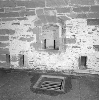 Interior. Detail of grill over fresh water cistern fed with rainwater from roof