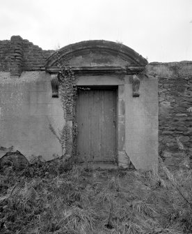 Detail of pedimented doorway in garden wall.