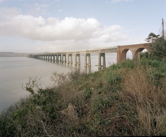 General view of west side of bridge from SSW, with first arches of red-brick viaduct visible (right)