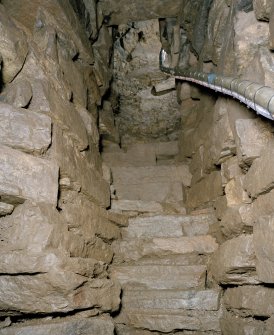 View up lower flight of steps from cistern to half-landing, after installation of handrail.
