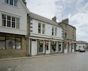 View from N showing shopfront with cast iron corinthian columns